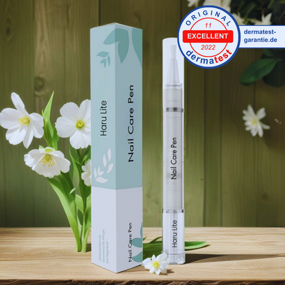 Haru Lite Nail Care Pen with packaging on a wooden surface with flowers in the background
