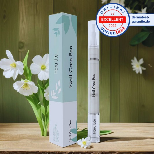 Haru Lite Nail Care Pen with packaging on a wooden surface with flowers in the background